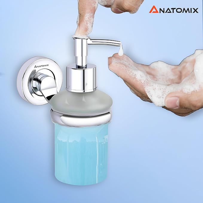 A soap dispenser made of stainless steel. A hand showing the soap emerge from the liquid soap dispenser